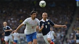 Milan Biševac of Serbia and Scotland's Kenny Miller keep their eyes on the ball
