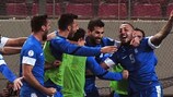 Greece celebrate one of Kostas Mitroglou's two goals against Romania