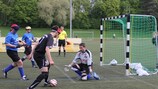 Playing football, and being part of a team at a match in Germany.