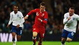 Aaron Ramsey evades Wayne Rooney during one of Wales' EURO 2012 qualifiers against England