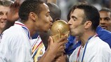 Thierry Henry and Youri Djorkaeff kiss the World Cup trophy in 1998