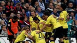 Shinji Kagawa is mobbed after opening the scoring against Schalke