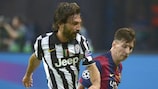 Andrea Pirlo (left) contests possession with Lionel Messi in the 2015 final