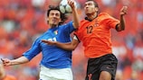 Italy's Marco Delvecchio (left) jumps with Giovanni van Bronckhorst during the sides' semi-final meeting at UEFA EURO 2000™