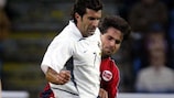 Luís Figo attempts to hold off Martin Andersen during a friendly in 2003