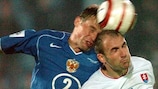 Róbert Vittek (right) jumps with Russia's Vasili Berezutski during a 2006 World Cup qualifier