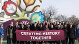 Representatives from UEFA, Ukraine, Poland and the eight host cities pose in front of the UEFA EURO 2012 logo
