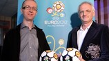 Tomasz Bagiński and Krzesimir Dębski pose with a EURO 2012 football in Warsaw