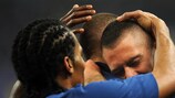Florent Malouda congratulates Karim Benzema after his winning goal against Brazil