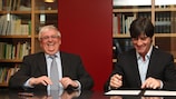 Joachim Löw signs his new deal along with Dr Theo Zwanziger at DFB headquarters in Frankfurt