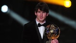 Lionel Messi shows off his 2010 FIFA Ballon d'Or award