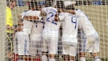 Greece players rush to congratulate Sotiris Ninis on his winning goal at the Bloomfield Stadium