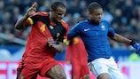 France's Loïc Rémy is challenged by Belgium defender Vincent Kompany