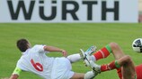 Luxembourg's René Peters (in white) goes in for a challenge against Belarus