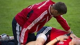 Christian Poulsen does stretching exercises in a Danish training session