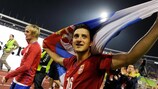 Midfielder Zdravko Kuzmanović holds a Serbian flag aloft after Saturday's 5-0 win over Romania