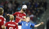 Andreas Bjelland rises to head the ball for Denmark in a challenge with Iceland's Kolbeinn Sigthórsson