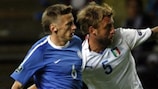 Aleksandr Dmitrijev goes shoulder to shoulder with Daniele De Rossi during Estonia's defeat by Italy