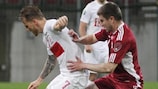 Poland's Eugen Polanski (L) takes on Latvia's Aleksandrs Fertovs in a 22 May friendly