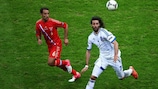 Roman Shirokov (left) keeps a close eye on Greece striker Giorgos Samaras
