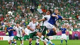 Antonio Cassano rises above Ireland midfielder Keith Andrews to glance in Italy's first goal