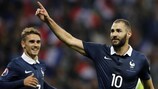 Karim Benzema enjoys one of his two late goals for France