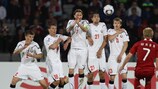 The Belarus defensive wall rises to fend away a free-kick against Denmark