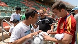 Spain's Nacho signs some autographs after a training session