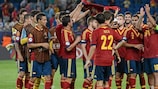 The Spain players hold up the shirt of injured team-mate Sergio Canales after their win