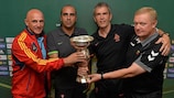 Coaches of the Group A teams pose with the U19 trophy