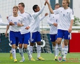 Tim Väyrynen (right) of Finland is congratulated after one of his three goals