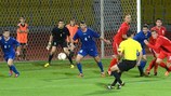 Goalkeeper Alexei Koselev and defender Ion Prodan (No4) look to block a shot for Moldova