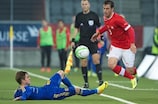 Switzerland's Bruno Martignoni skips past the tackle of Vladyslav Kalitvintsev