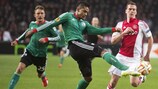 Dossa Júnior of Legia looks to clear past Ajax's Arkadiusz Milik