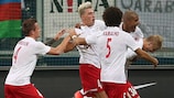 Salzburg players leap onto the back of Martin Hinteregger after the defender scored