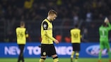 Marco Reus looks dejected at full time as his Dortmund team-mate applaud their support