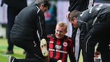 Sebastian Rode is assessed after going to ground with a knee injury against Bremen