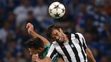 PAOK's Miguel Vítor jumps for a high ball with Julian Draxler during the first leg in Germany