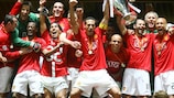 Manchester United players celebrate with the trophy in Moscow