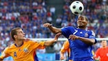 Gabriel Tamaş of Romania and Florent Malouda of France battle for the ball