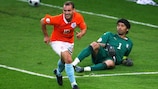 Italy keeper Gianluigi Buffon lies on the turf as scorer Wesley Sneijder wheels away