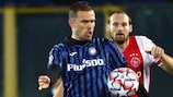 Atalanta's Josip Iličić and Ajax's Daley Blind keep their eyes on the ball