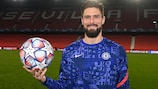 Chelsea's Olivier Giroud poses with the match ball after scoring four goals  at Sevilla in the group stage