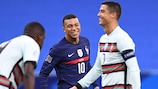 France's Kylian Mbappé (C) shares a laugh with Portugal's Cristiano Ronaldo in 2020