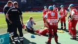 The medical team are given advice prior to the EURO group stage match between Denmark and Belgium in Copenhagen