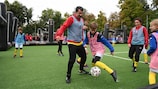 Football greats Luís Figo (centre) and Nadine Kessler (right) playing at the Chişinău grassroots event