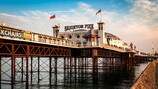 Brighton, UK - August 25, 2016: Brighton Pier at sunset in Sussex, England, UK