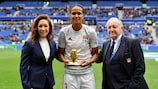 Wendie Renard receives an award to mark her 100th UEFA club game from UEFA chief of women's football Nadine Kessler and Lyon president Jean-Michel Aulas