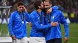 Giorgio Chiellini receives a parting gift from Italy team-mate Manuel Locatelli after the Finalissima