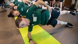 French referee Stéphanie Frappart (front) and colleagues undertake a stretching exercise 